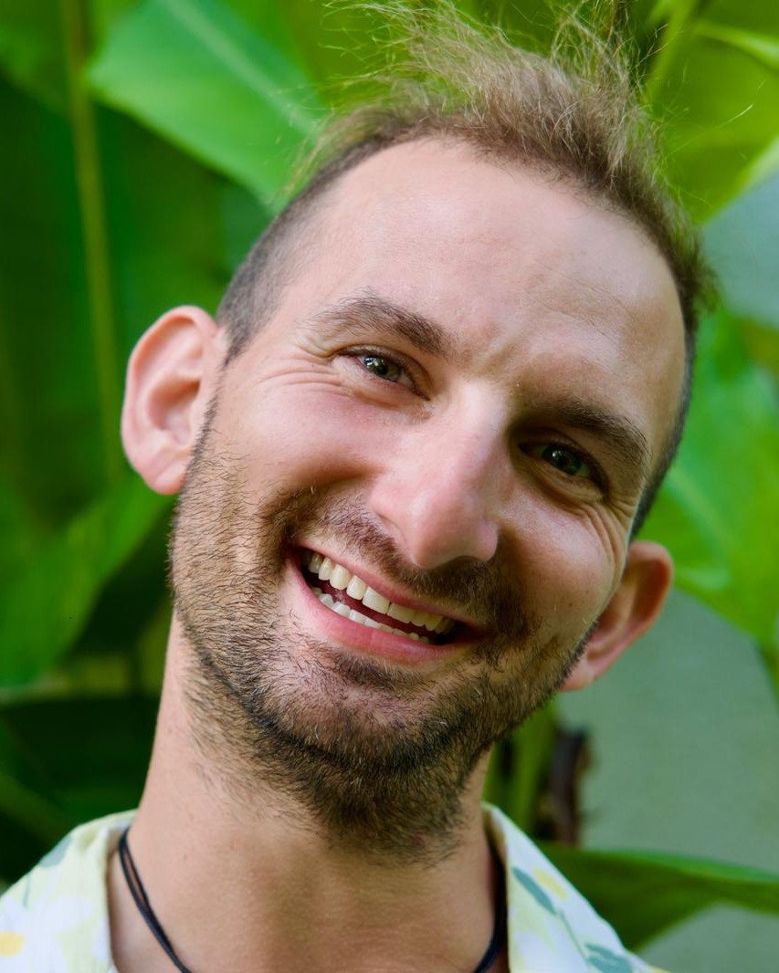 Marcus Levine smiling in a green shirt
